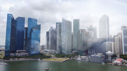 Fototapeta na wymiar SINGAPORE - JANUARY 4, 2020: Aerial view of city skyline and Marina Bay area at sunset