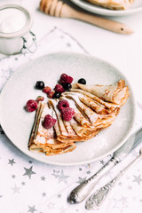 Pancakes with wild berries in a plate.Maslenitsa