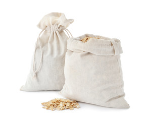 Cotton eco bags with oat flakes isolated on white