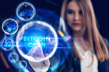 Business, Technology, Internet and network concept. Young businessman working on a virtual screen of the future and sees the inscription: Bitcoin cash