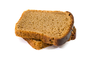 Two slices of rye bread on a white background. Delicious, brown bread. Close-up.