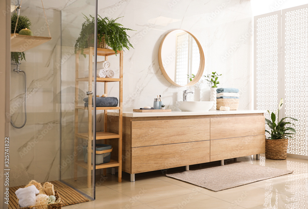 Wall mural Stylish bathroom interior with countertop, mirror and shower stall. Design idea