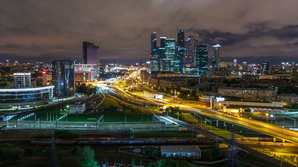 Fototapeta na wymiar Night view of the city traffic timelapse and Building of Moscow International Business Center Moscow-City