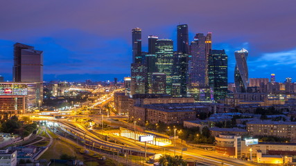Fototapeta na wymiar Night to day view of the city traffic timelapse and Building of Moscow International Business Center Moscow-City