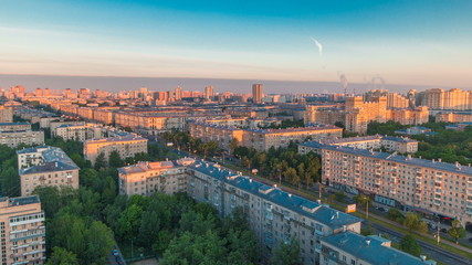 Fototapeta na wymiar Moscow city bathed in yellow sun at dawn timelapse. An early foggy morning. Shadows moving on houses. Megalopolis aerial view from rooftop.