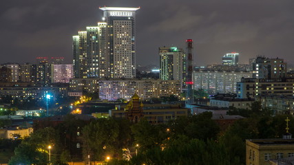 Fototapeta premium Night Moscow cityscape from rooftop timelapse. Residential buildings at night. Night view from the roof