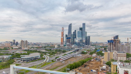 Naklejka na ściany i meble Business complex of skyscrapers Moscow city timelapse. In the foreground the railway and automobile overpass.