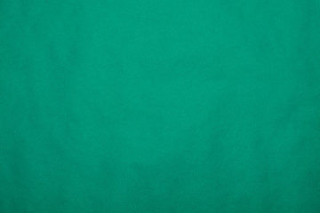Background from green paper. Crumpled paper texture. Background, texture of colored parchment paper.