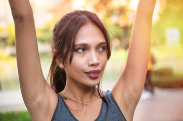 Beautiful asian woman outdoor doing physical exercises. Fitness concept