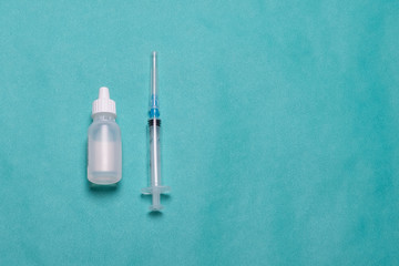 Syringe on a blue background. Medical syringe studio image. Syringe with ampoules.