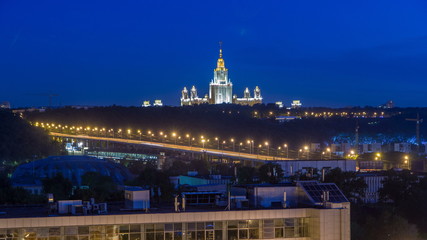 Fototapeta na wymiar Night cityscape view of Moscow timelapse. View from rooftop to the main building of Moscow State University at night