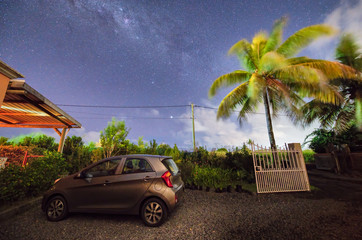 Parked car in a beautiful park under the milky way