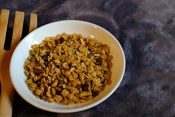 Fototapeta premium Cereal breakfast with Whole Grain Oats and Dried Strawberry. Tasty and perfect for breakfast, a healthy snack, workout meal or as ice cream toppings. Top view, flat lay.