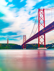 Lisbon landscape at sunset.Panoramic photograph of the 25 de Abril bridge in the city of Lisbon over the Tajo River