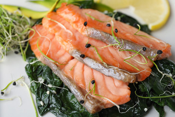 Tasty freshly cooked salmon with spinach, closeup