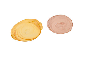 Liquid body and face highlighter isolated on white background. Golden and beige color.