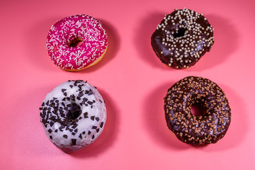 Fresh glazed donuts isolated on a pink background