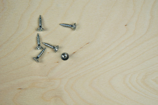 silver screws on wooden panel