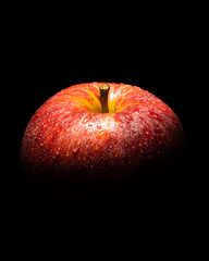 red apple on black background