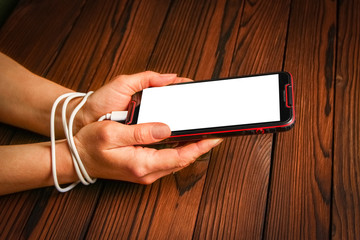 a phone with hands addiction on a wooden background