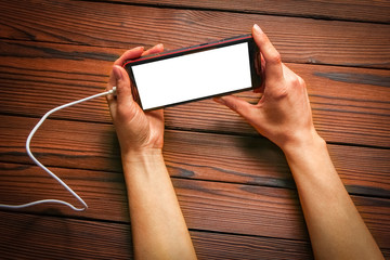 a phone with hands addiction on a wooden background