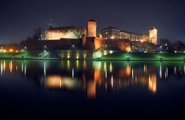 Fototapeta na wymiar Wawel Castle by the river at night in Krakow.