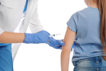 Little girl receiving chickenpox vaccination on white background, closeup. Varicella virus...