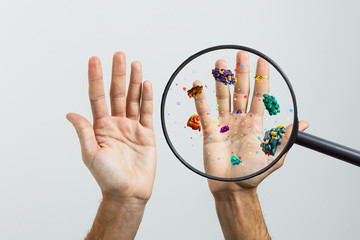 Hygiene concept. Man is showing dirty hands with many viruses and germs.