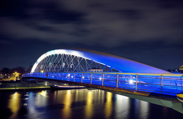 Obraz premium Father Bernatek's Bridge in Krakow at night.