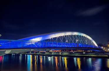 Father Bernatek's Bridge in Krakow at night.