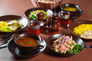 Georgian lunch borscht with salad on the table