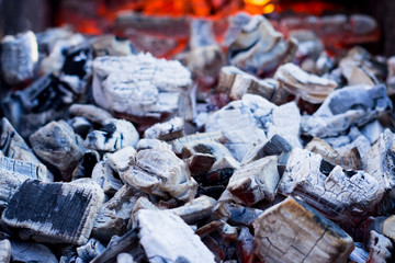 Background image of fire and hot coals in close-up.