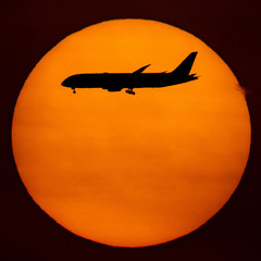 Naklejka na ściany i meble Silhouette of passenger airplane with the morning sunrise background