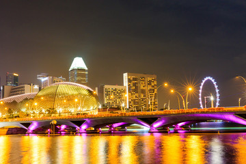 Singapore city skyline at night of the Esplanade Theater and Singapore Flyer taken from the Anderson Bridge (Fullerton Road), Marina Bay.