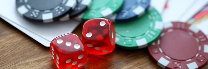 Red dices lying with casino chips as gambling symbol