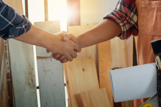 Close up view of two workers shaking hands after successful deal, Craftsman concept
