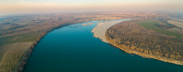 Po river seen from above in winter day. Aerial view of the Lombard plain and floodplains near the river. Lombardy, Italy.