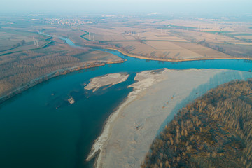 Aerial view of the Po river at the confluence with the Lambro river. Plain landscape in Lombardy (Italy).