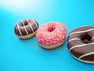 three sweet doughnuts on a blue background close up