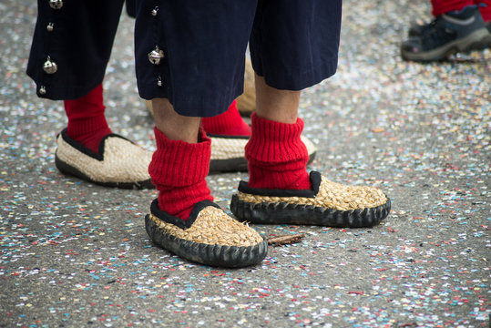 Closeup Of Feet Of Man Wearing Red Socks In The Street During The Carnival