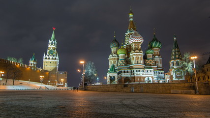 Moscow Kremlin timelapse hyperlapse with Spasskaya tower and Cathedral of St. Basil, Russia. Red Square in winter night