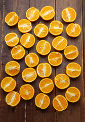 juicy halves of oranges on brown table
