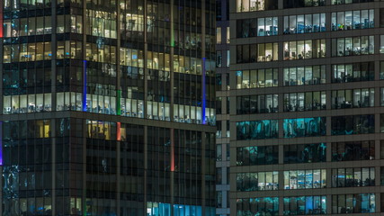 Fototapeta na wymiar Close up view to office windows in Skyscrapers Moscow-City at night timelapse from top, Moscow, Russia 4K