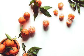 beautiful ripe tangerines with green leaves on wooden plate