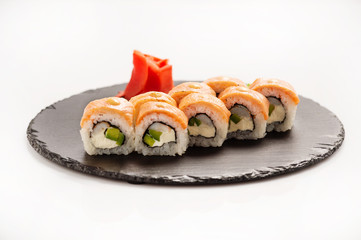 Sushi roll Philadelphia on a black round stone.