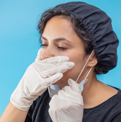 Sick girl in a medical mask on a blue background
