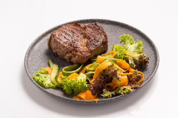 Beef steak with salad on a plate