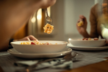 Close-up of couple having dinner at dining table.