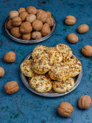 Homemade walnut cookies with walnuts on dark background,top view