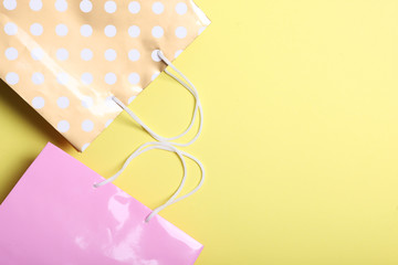 packages for shopping on a colored background top view. Minimalism, place for text.